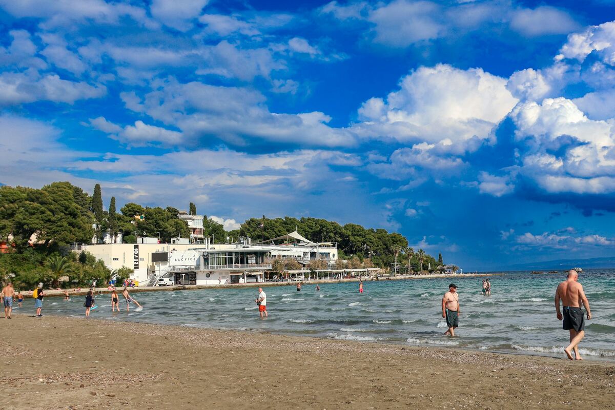 Swimmers in the shallow sandy bay of Bačvice beach