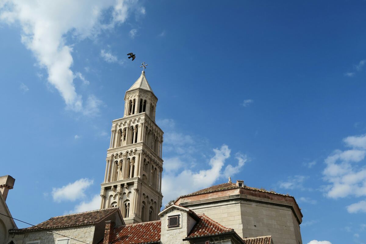 The Romanesque bell tower of the Cathedral of St Domnius against a blue sky