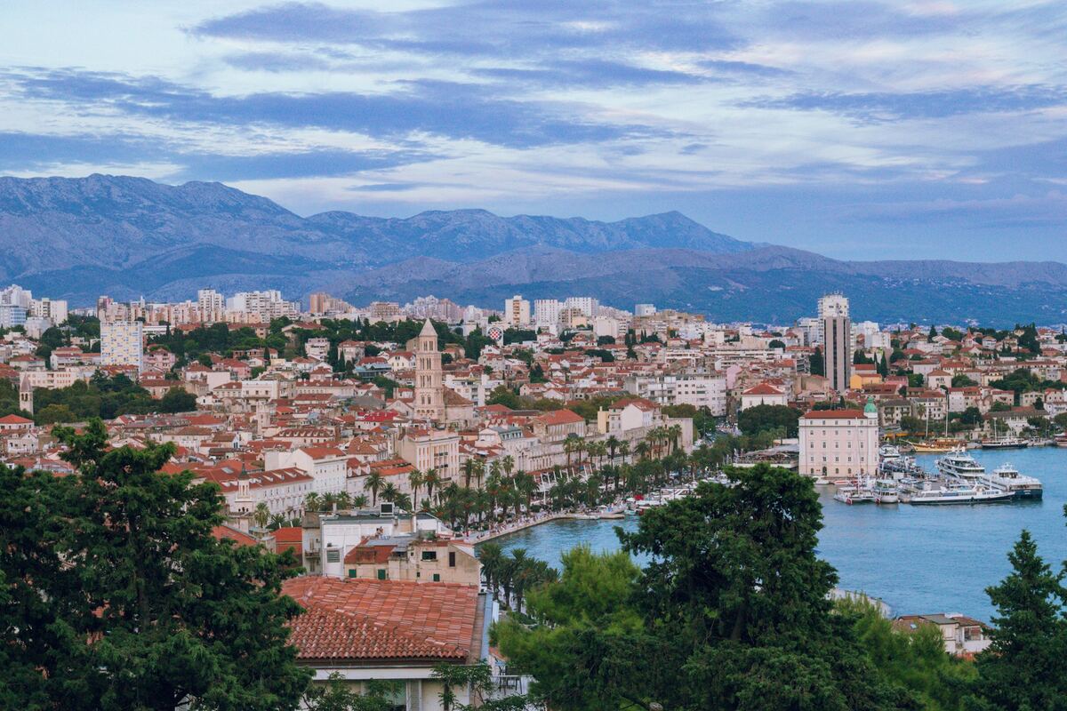 Split's old town, harbour and mountains seen through the pines of Marjan hill