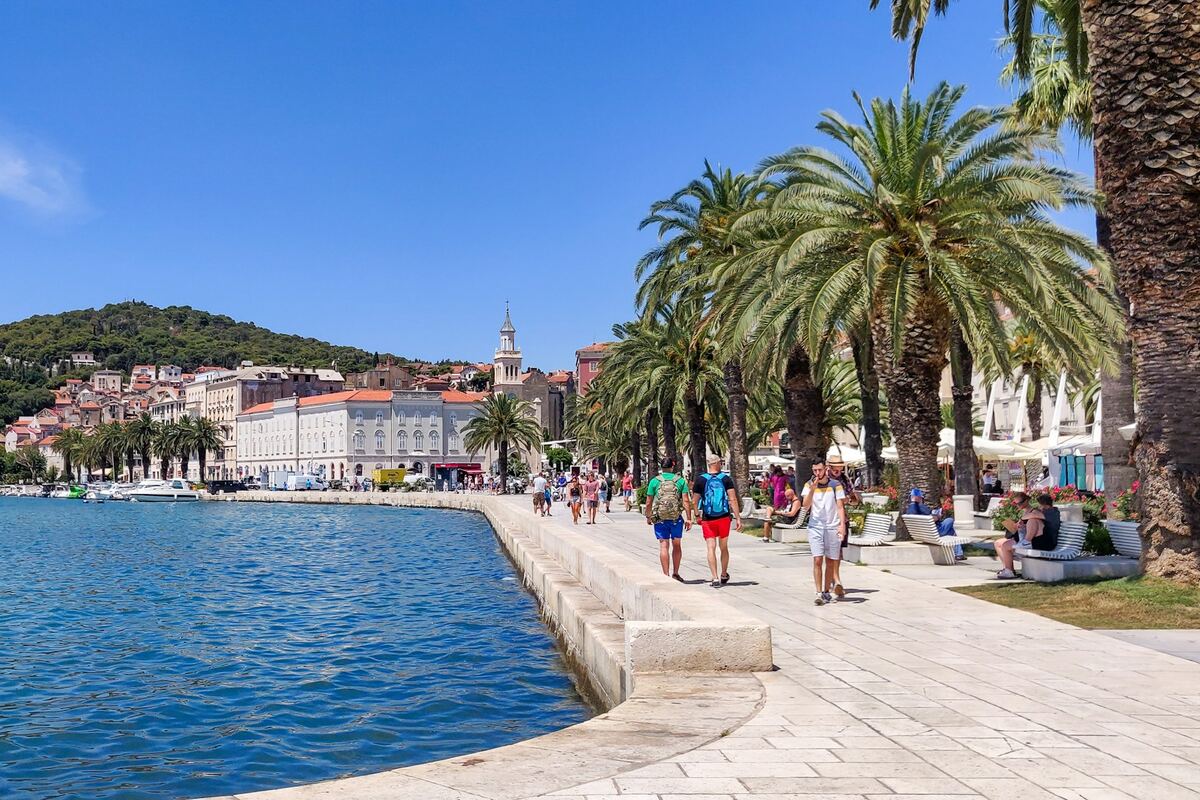 Palm trees and strollers along the Riva waterfront in Split